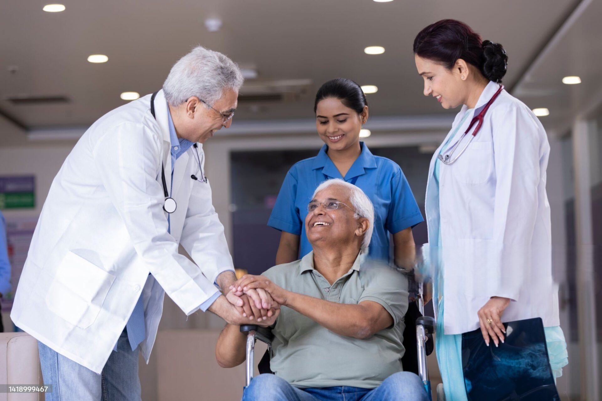 Doctors comforting disabled elderly patient
